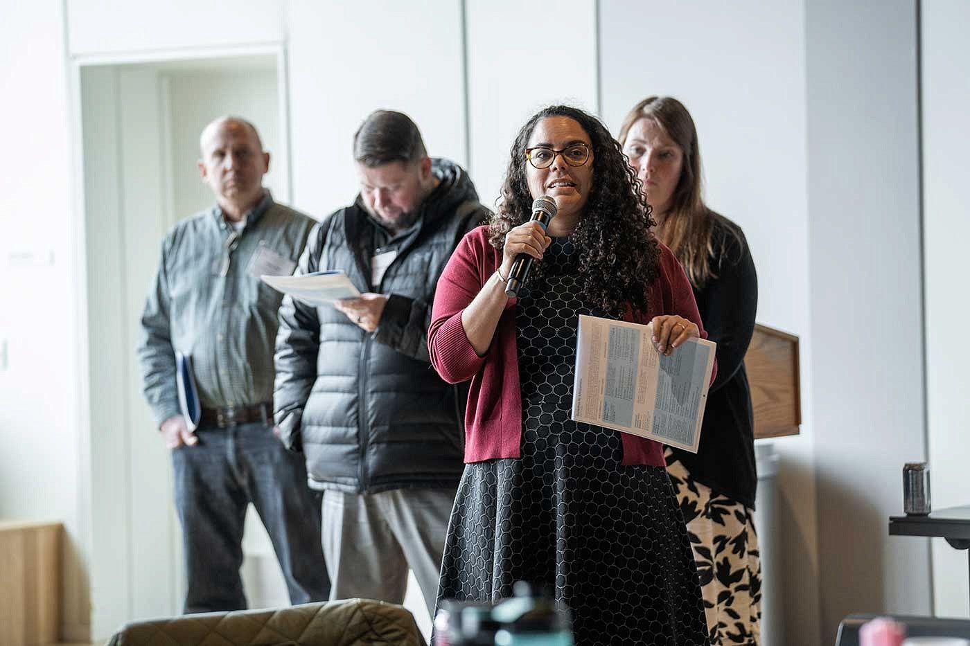 woman with microphone in front of a group