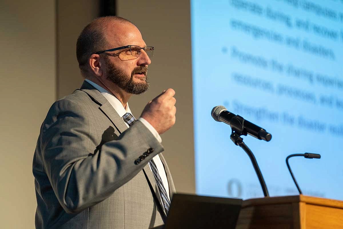 Andre Le Duc speaking at podium