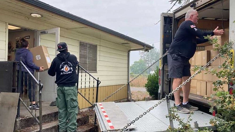 Staff and volunteers at Oakridge Air distribute air purifiers to the community. 