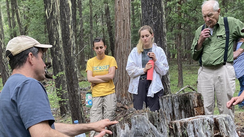 James Johnston explains how trees record fires in the annual growth rings James Johnston explains how trees record fires in the annual growth rings during a field trip to the Willamette National Forest.