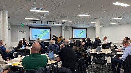 Presenting continuity plans to large room of Summit attendees.