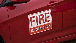 Red vehicle with fire information sign on side