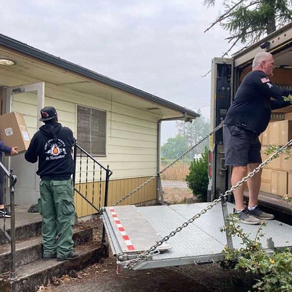 Staff and volunteers at Oakridge Air distribute air purifiers to the community. 