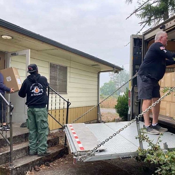 Three people distributing air filters